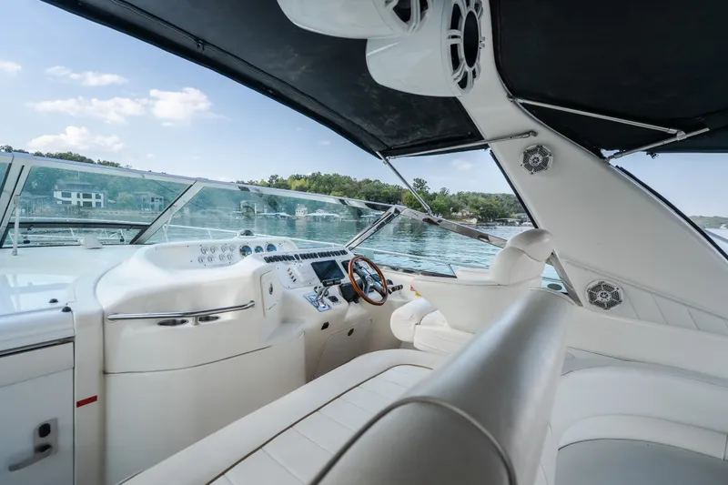 Slide: The Image of 1997 Sea Ray Sundancer 400 yacht cockpit with luxurious white seating and scenic water view. - 35