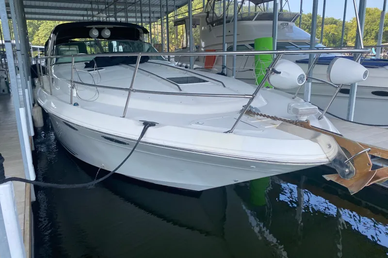 Slide: The Image of 1997 Sea Ray 40 Sundancer yacht docked in a marina, front view. - 37
