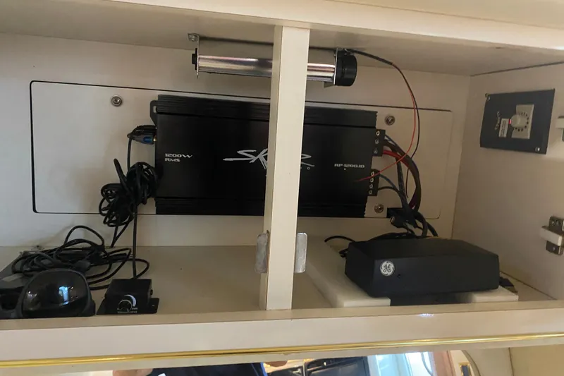 Slide: The Image of 1997 Sea Ray 40 Sundancer interior electronics setup with amplifier and wiring. - 24