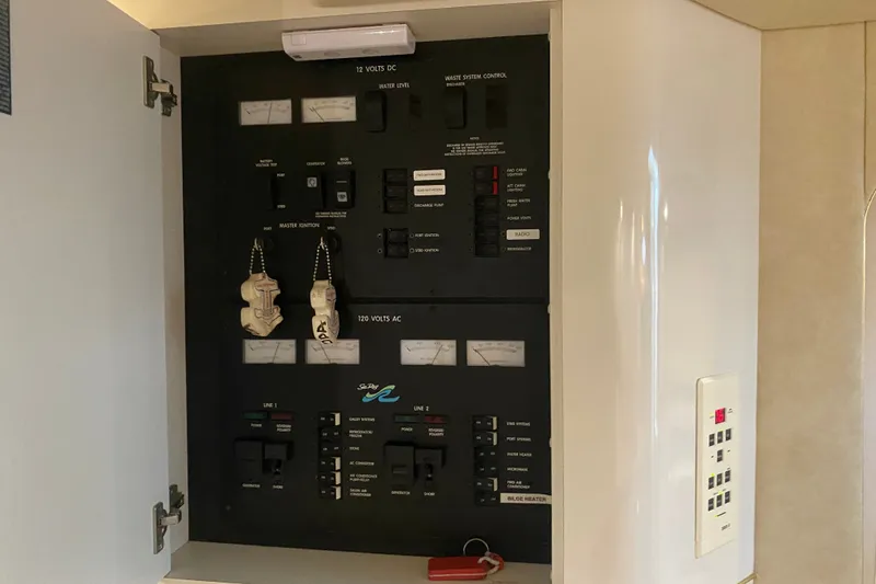 Slide: The Image of Electrical panel inside a 1997 Sea Ray 40 Sundancer boat, showing switches and controls. - 17