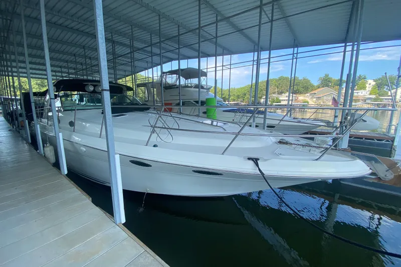The Image of 1997 Sea Ray 40 Sundancer yacht docked in a covered marina. - 1