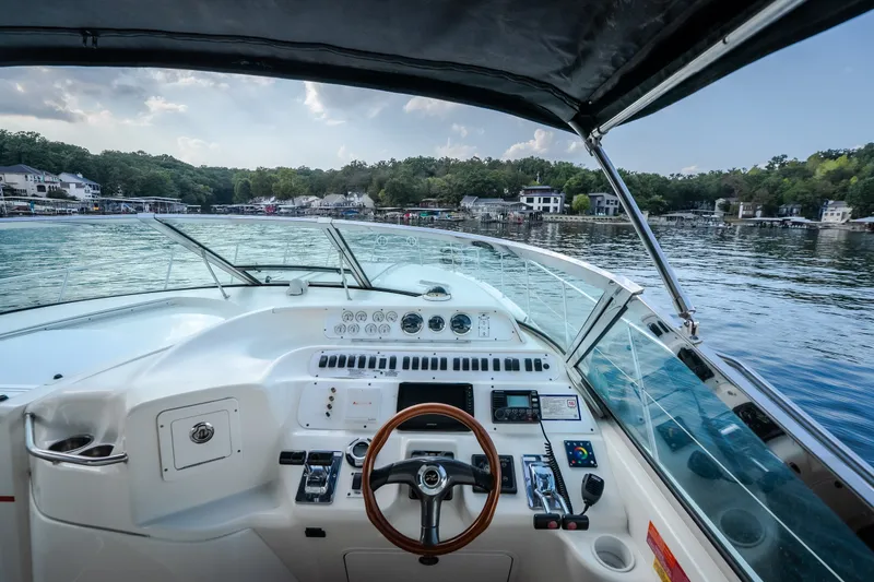 Slide: The Image of 1997 Sea Ray Sundancer 400 helm with scenic waterfront view. - 42