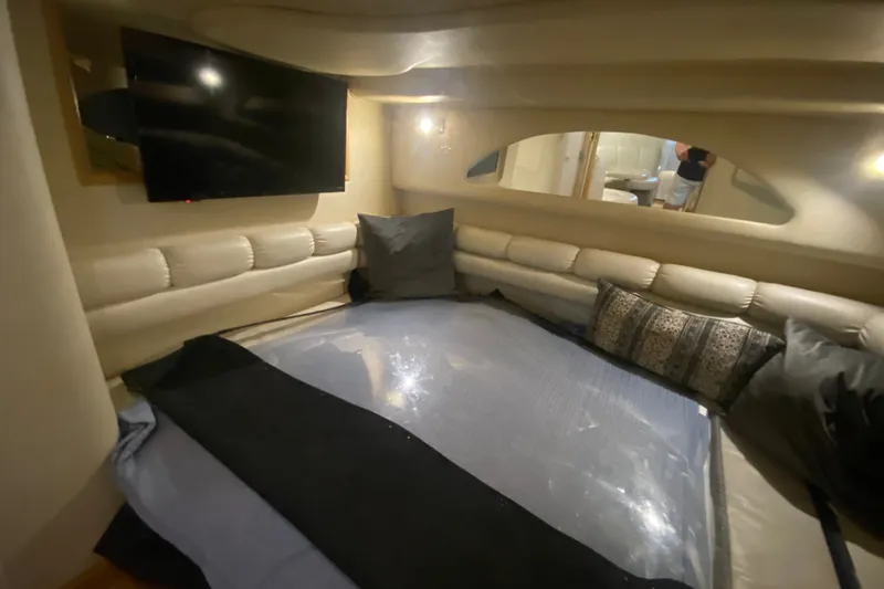 Slide: The Image of Luxurious interior cabin of a 1997 Sea Ray 40 Sundancer yacht with plush seating and TV. - 23