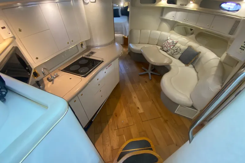 Slide: The Image of Interior of 1997 Sea Ray 40 Sundancer yacht with kitchen and seating area. - 13