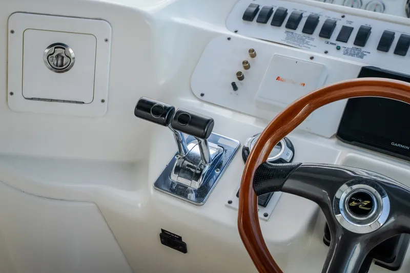 Slide: The Image of 1997 Sea Ray Sundancer 400 helm with wooden steering wheel and control panel. - 24