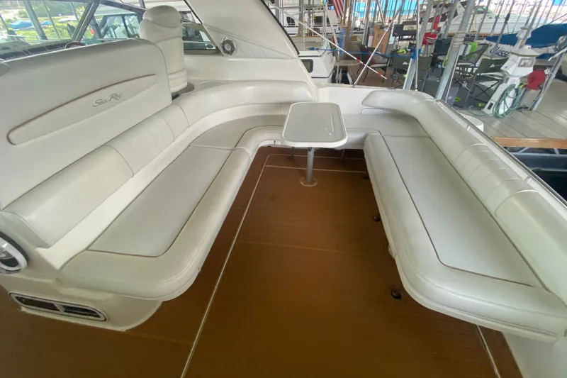 Slide: The Image of Luxurious seating area on a 1997 Sea Ray 40 Sundancer yacht with white upholstery. - 27