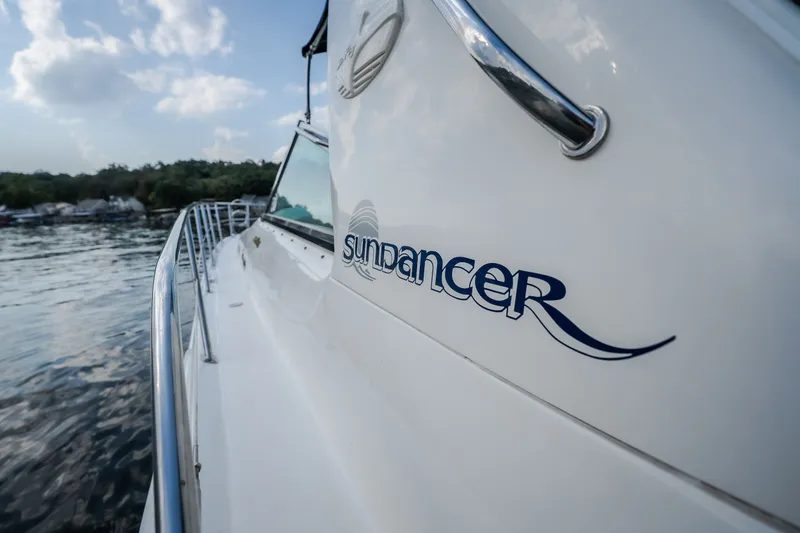 Slide: The Image of 1997 Sea Ray Sundancer 400 yacht on calm water, showcasing sleek design and branding. - 37