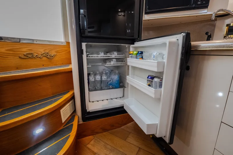 Slide: The Image of Interior of a 1997 Sea Ray Sundancer 400 yacht featuring an open refrigerator. - 60