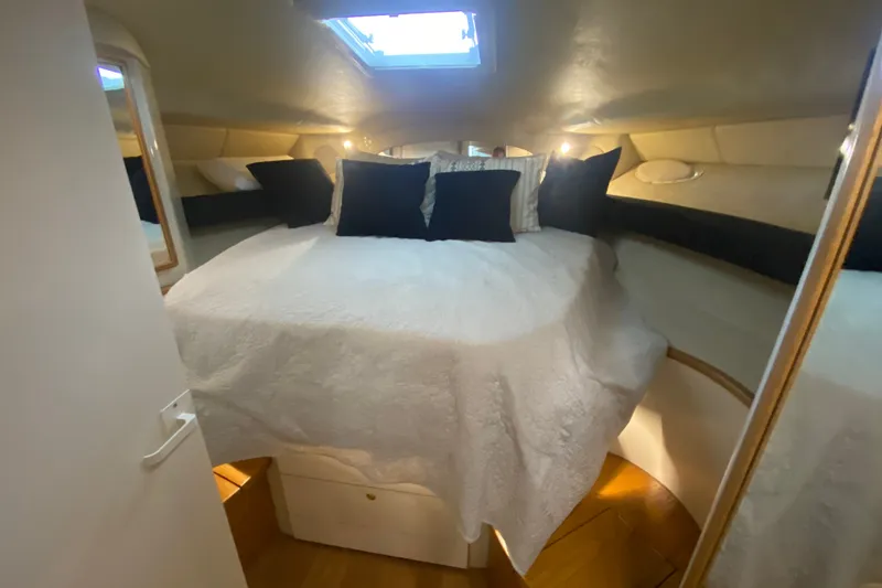 Slide: The Image of 1997 Sea Ray 40 Sundancer cabin with cozy bed and ambient lighting. - 18