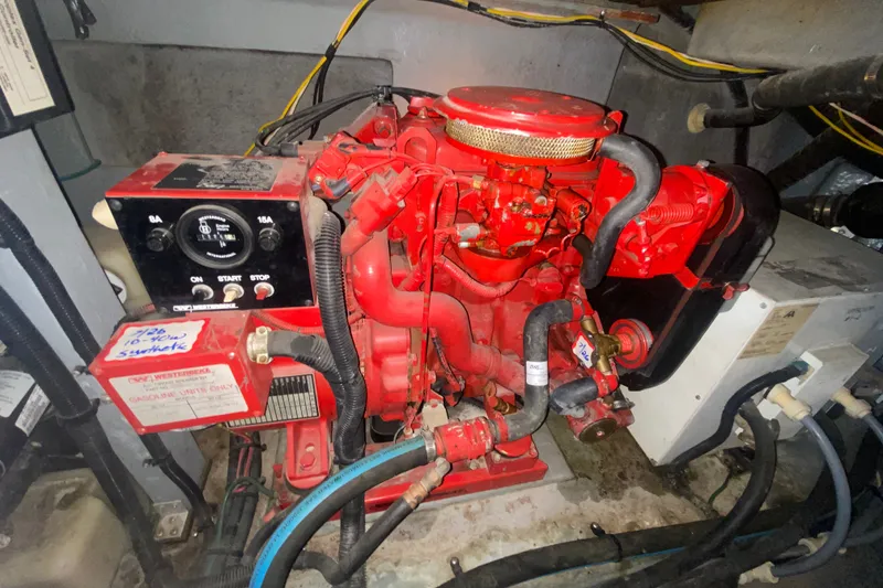 Slide: The Image of Engine compartment of a 1997 Sea Ray Sundancer 400, featuring a red engine and control panel. - 74