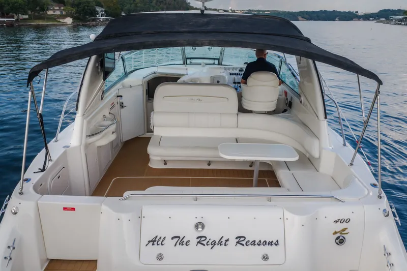 Slide: The Image of 1997 Sea Ray Sundancer 400 yacht with spacious deck and seating on a calm lake. - 66