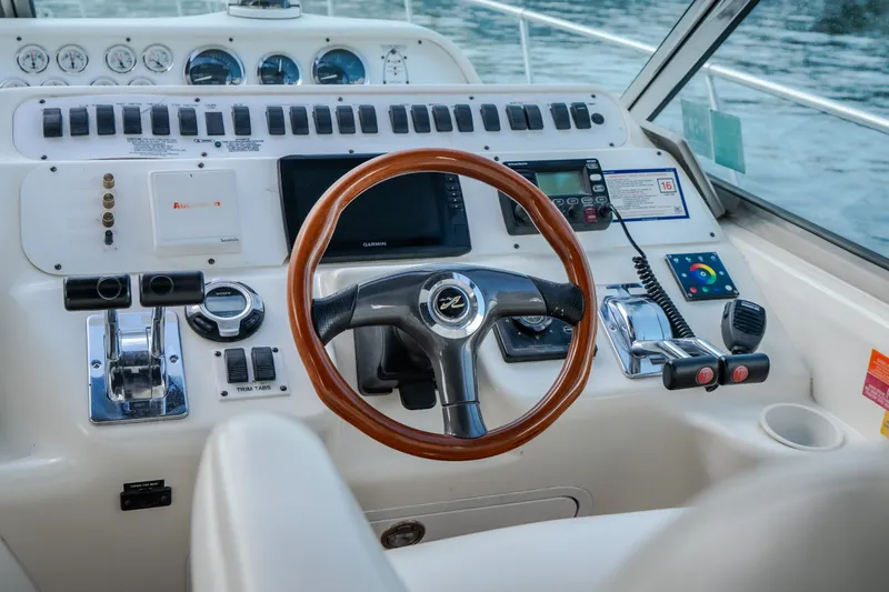 Slide: The Image of Cockpit of 1997 Sea Ray Sundancer 400 with steering wheel and control panel. - 41