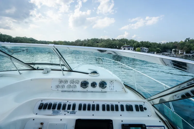 Slide: The Image of Cockpit view of 1997 Sea Ray Sundancer 400 on a serene lake. - 9