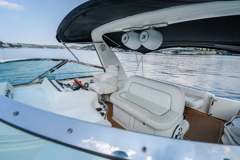 Slide: The Image of 1997 Sea Ray Sundancer 400 yacht interior with white seating and lake view. - 32