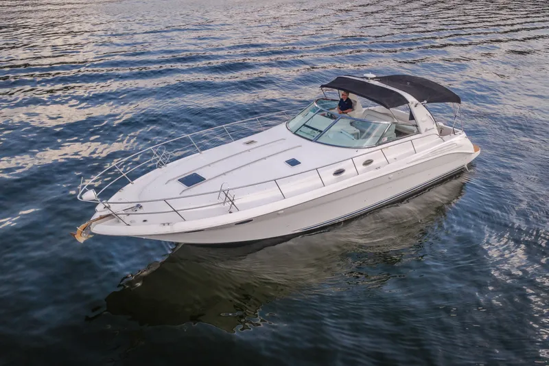 Slide: The Image of 1997 Sea Ray Sundancer 400 yacht cruising on calm waters. - 0
