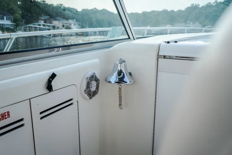 Slide: The Image of Interior view of a 1997 Sea Ray Sundancer 400 boat with a chrome bell and speaker. - 36