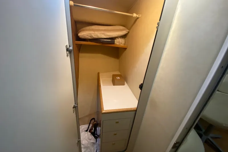 Slide: The Image of Interior closet of 1997 Sea Ray 40 Sundancer yacht with shelves and storage. - 21