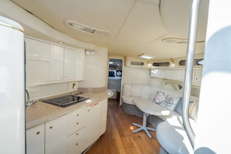 Slide: The Image of Interior of a 1997 Sea Ray Sundancer 400 yacht with modern kitchen and cozy seating area. - 45