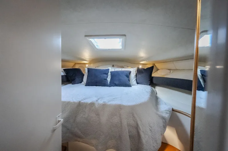 Slide: The Image of Cozy cabin interior of 1997 Sea Ray Sundancer 400 yacht with plush bedding and skylight. - 52