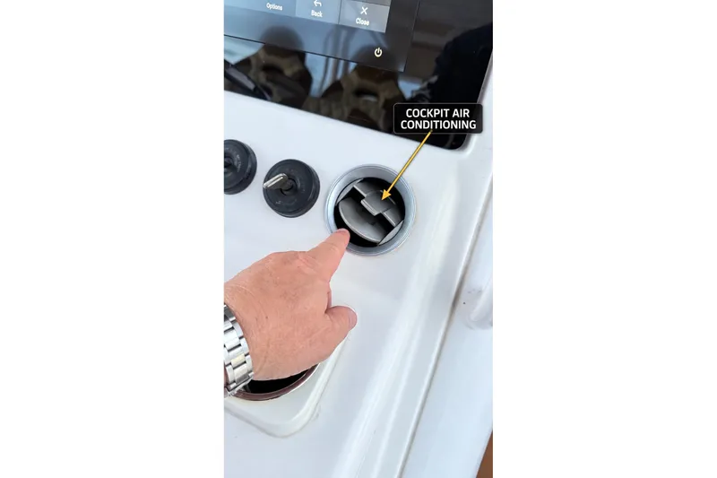 Slide: The Image of Hand adjusting cockpit air conditioning vent on 2008 Grady-White Express 330 boat. - 39