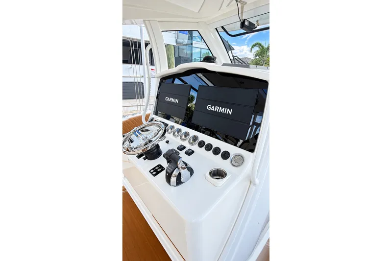 Slide: The Image of 2008 Grady-White Express 330 helm with Garmin navigation displays and controls. - 37
