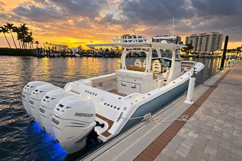 Slide: The Image of 2008 Grady-White Express 330 boat docked at sunset with triple Mercury engines. - 13