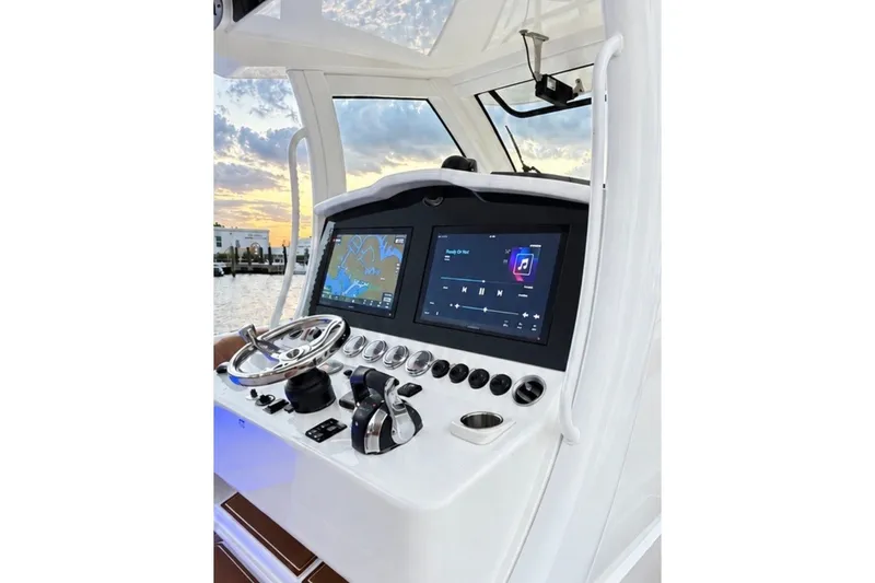 Slide: The Image of 2008 Grady-White Express 330 helm with dual screens and sunset view. - 36
