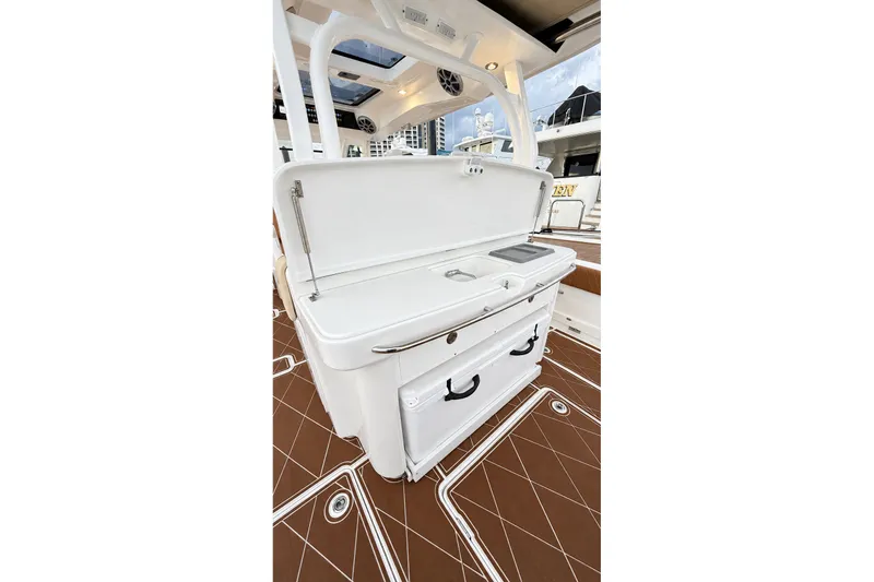 Slide: The Image of 2008 Grady-White Express 330 boat interior with white cabinetry and brown flooring. - 24