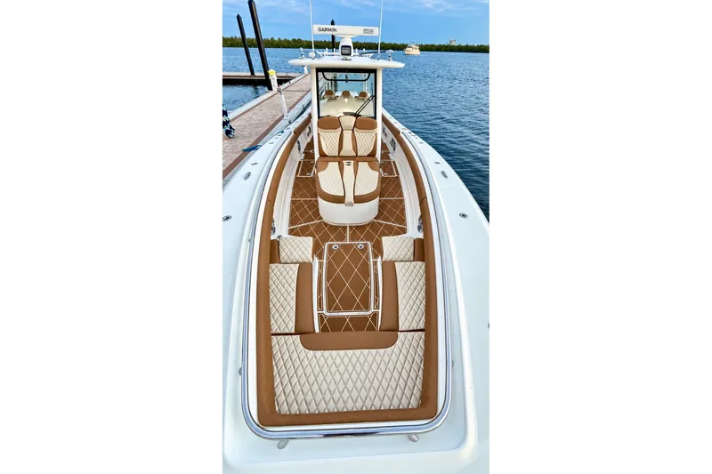 Slide: The Image of 2008 Grady-White Express 330 boat with luxurious seating, docked by the water. - 42