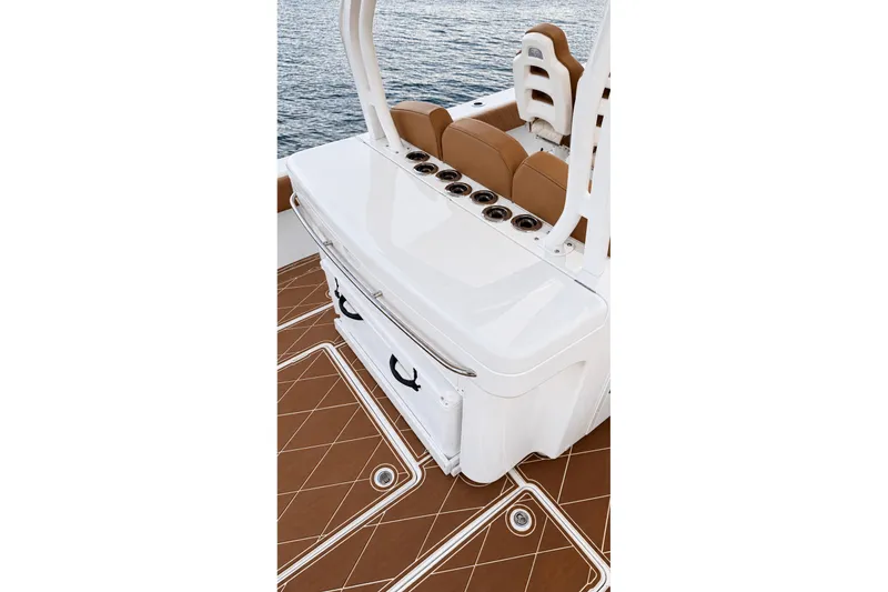 Slide: The Image of 2008 Grady-White Express 330 boat interior with seating and storage on water. - 25