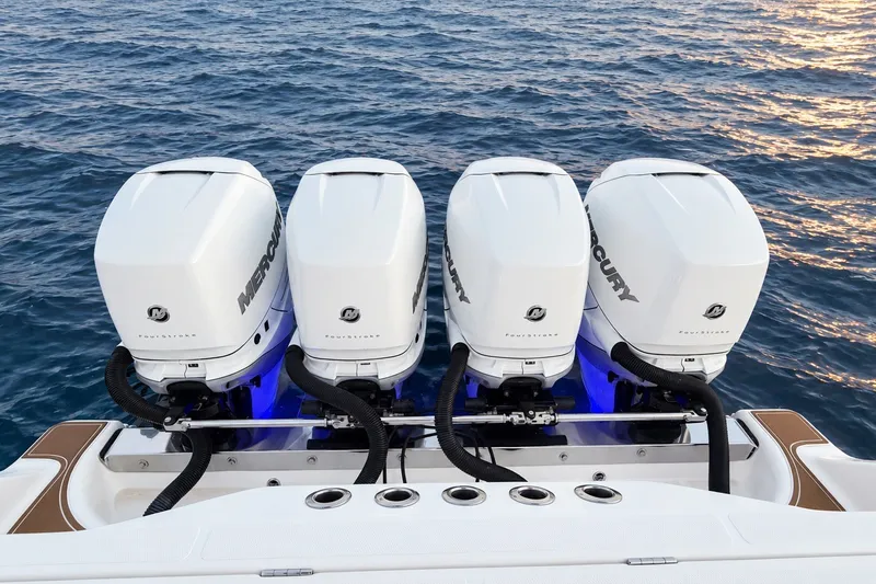Slide: The Image of Four Mercury outboard engines on a 2008 Grady-White Express 330 boat, ocean backdrop. - 18