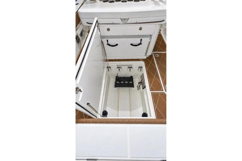 Slide: The Image of 2008 Grady-White Express 330 boat storage compartment with open hatch. - 56
