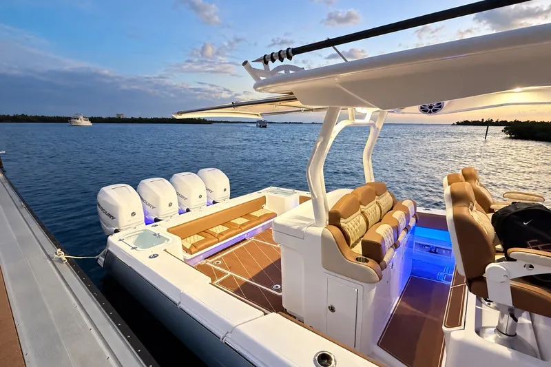 Slide: The Image of 2008 Grady-White Express 330 boat docked at sunset, featuring luxurious seating and multiple engines. - 31