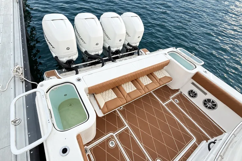 Slide: The Image of 2008 Grady-White Express 330 boat with four Mercury engines, docked on calm water. - 19