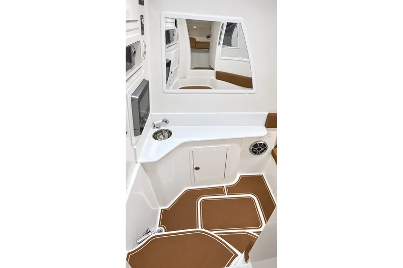 Slide: The Image of 2008 Grady-White Express 330 cabin interior with sink, mirror, and brown flooring. - 45