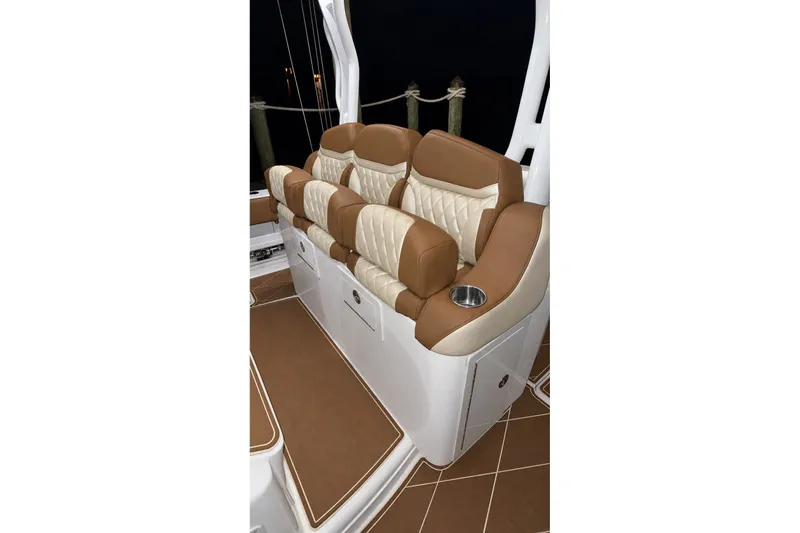 Slide: The Image of Luxurious seating on 2008 Grady-White Express 330 boat, featuring tan and cream upholstery. - 30