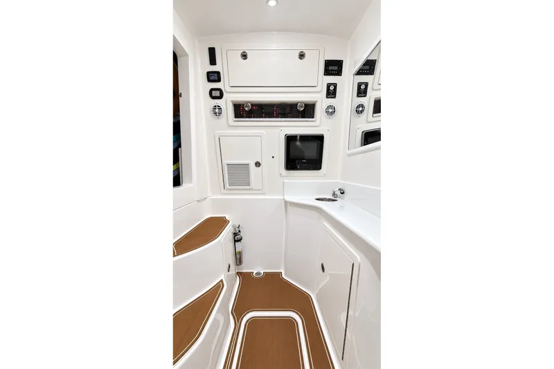 Slide: The Image of 2008 Grady-White Express 330 cabin interior with control panels and seating. - 49