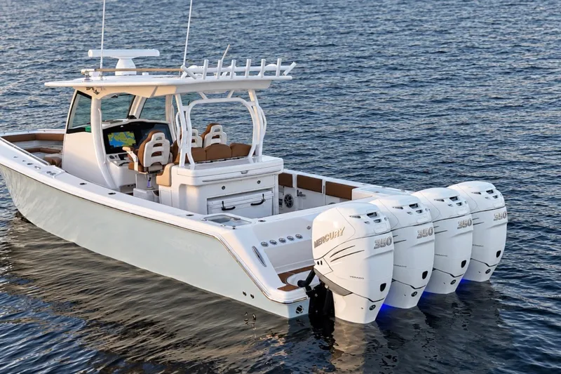 Slide: The Image of 2008 Grady-White Express 330 boat with four Mercury engines on open water. - 14