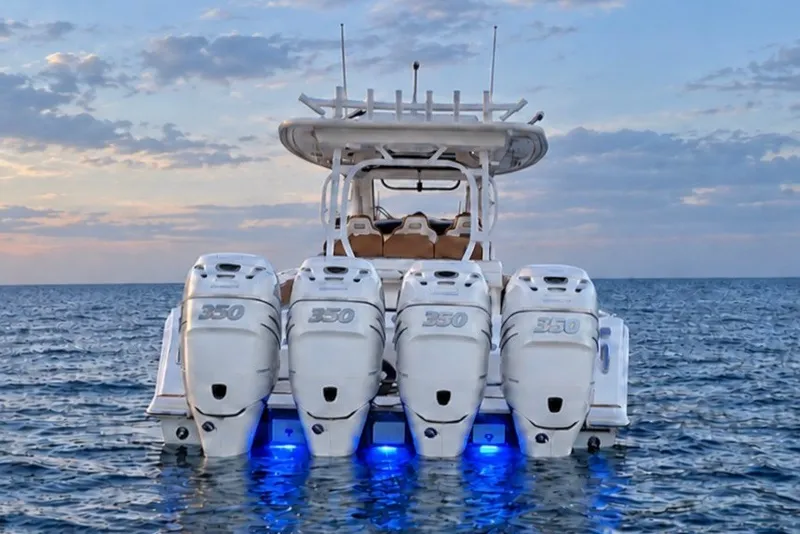 Slide: The Image of 2008 Grady-White Express 330 boat with four powerful engines on open water. - 12