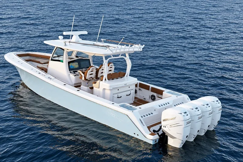 Slide: The Image of 2008 Grady-White Express 330 boat on open water, featuring multiple outboard engines. - 15
