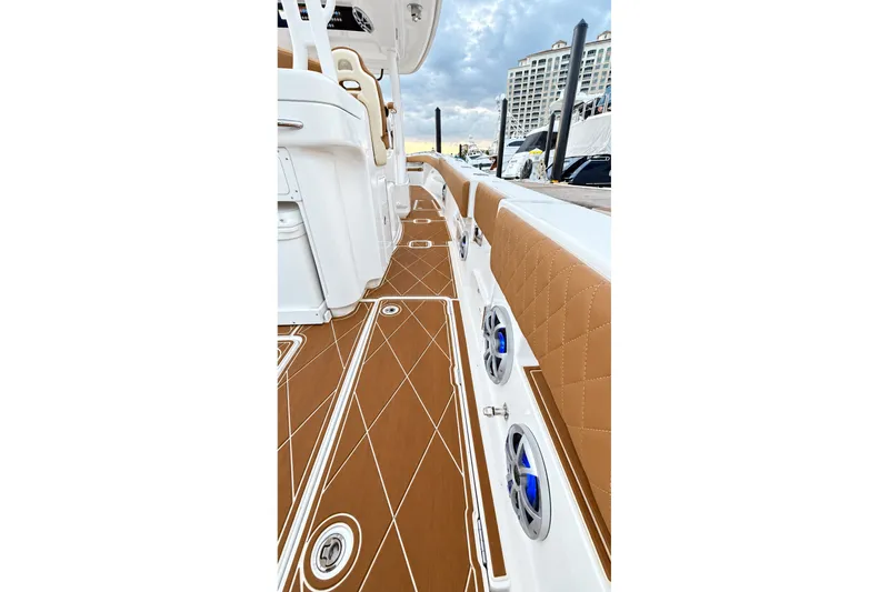 Slide: The Image of 2008 Grady-White Express 330 boat interior with brown diamond-patterned flooring and seating. - 40