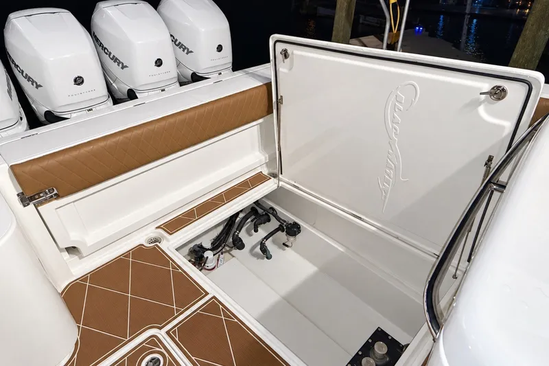 Slide: The Image of 2008 Grady-White Express 330 boat with Mercury outboard engines and open storage compartment. - 55