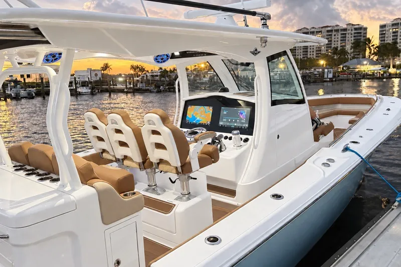 Slide: The Image of 2008 Grady-White Express 330 boat docked at sunset, featuring modern helm and seating. - 20