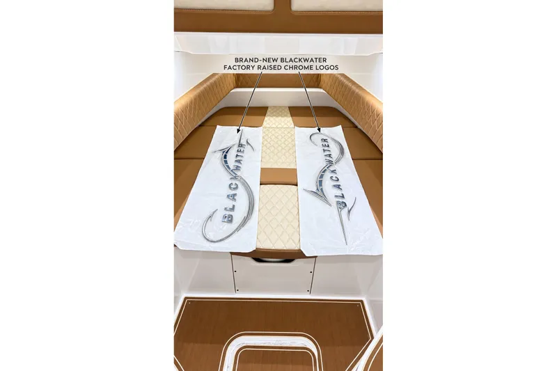 Slide: The Image of 2008 Grady-White Express 330 interior with Blackwater chrome logos on cushioned seating. - 47
