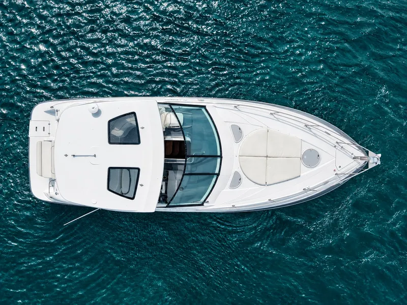 Slide: The Image of Aerial view of a white motor yacht on blue water. It features a spacious deck and modern design. - 11