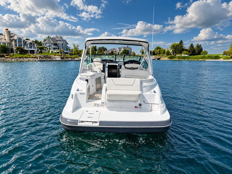 Slide: The Image of A 2020 Cruisers Yachts 35 Express on calm water. It features a spacious cockpit and white exterior. - 2