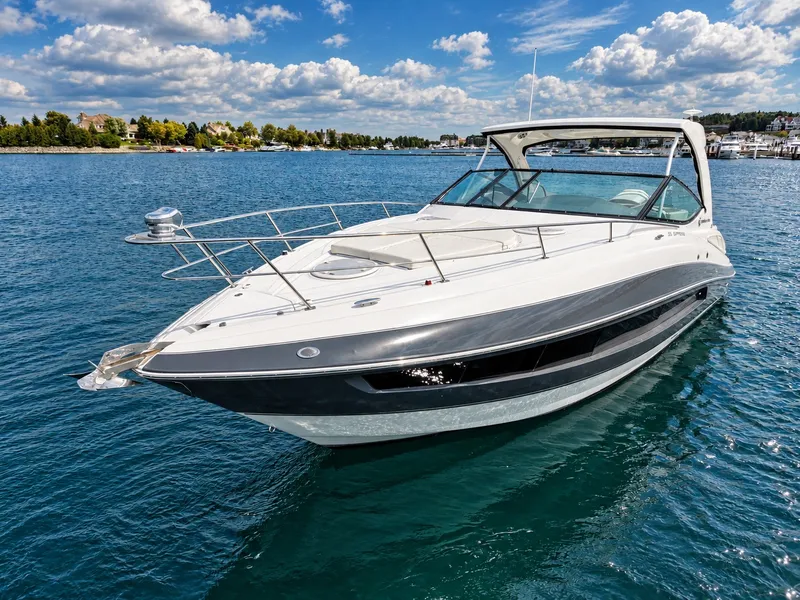 Slide: The Image of The 2020 Cruisers Yachts 35 Express glides elegantly over blue water under a clear sky. - 8