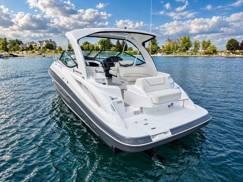 Slide: The Image of A luxurious 2020 Cruisers Yachts 35 Express on calm water, surrounded by scenic houses. - 1