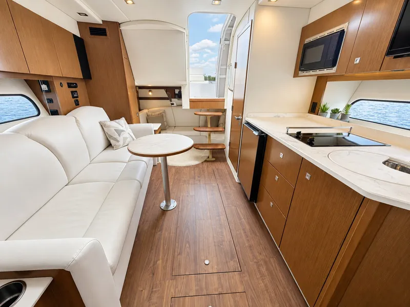 Slide: The Image of Interior of a 2020 Cruisers Yachts 35 Express with elegant furnishings and a modern kitchen. - 41