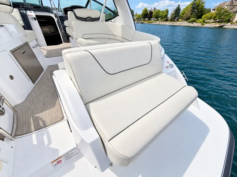 Slide: The Image of The 2020 Cruisers Yachts 35 Express features a luxurious white bench seat at the stern overlooking the water. - 21